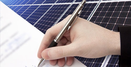 Person signing a solar system warranty