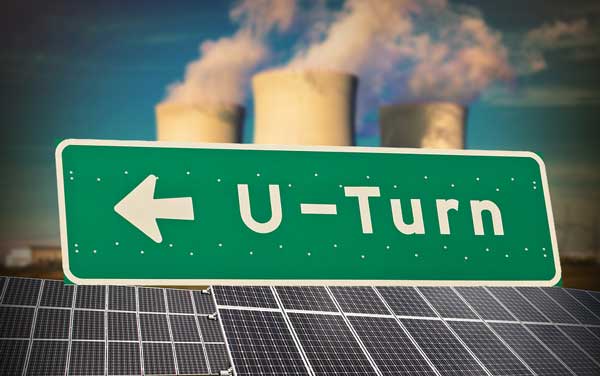 u turn sign in front of solar power and cooling towers