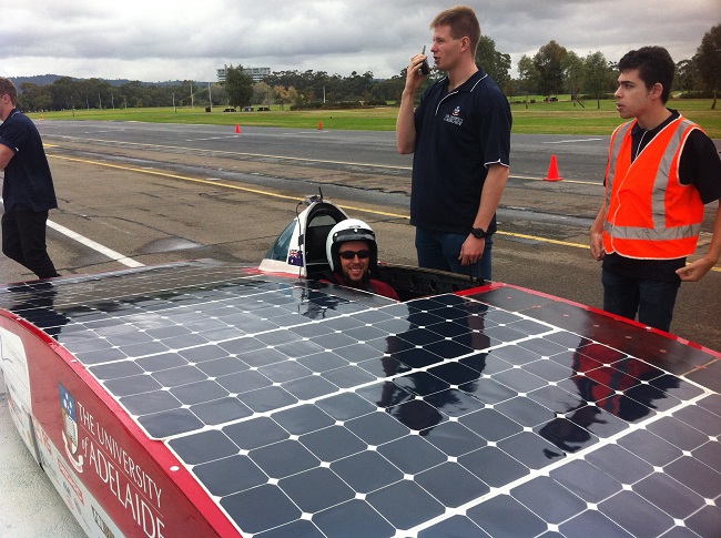 Finn Peakcock sitting in the cockpit of the Adelaide University's Solar Racing Team's Car, Lumen, about to take it for a drive.