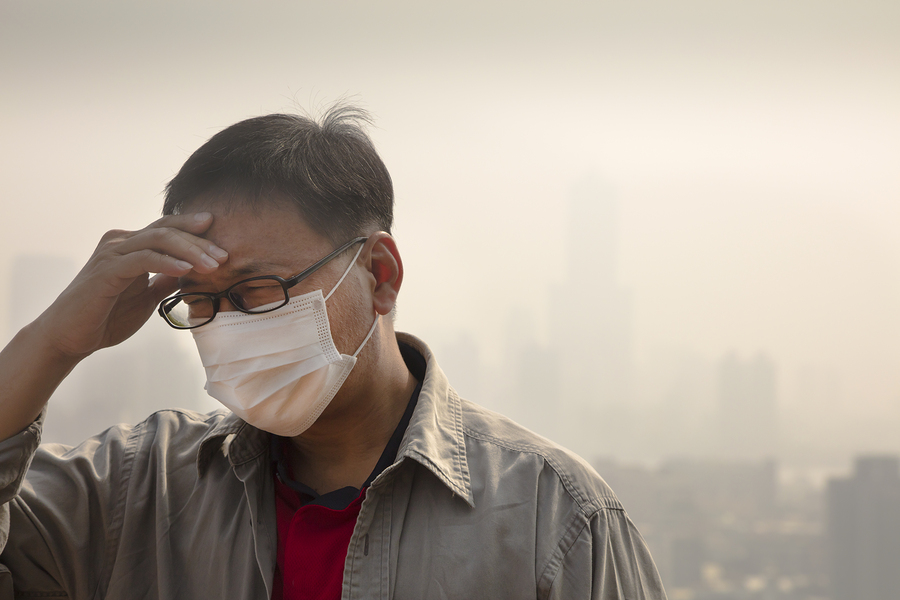 Asian Man Wearing Mouth Mask Against Air Pollution