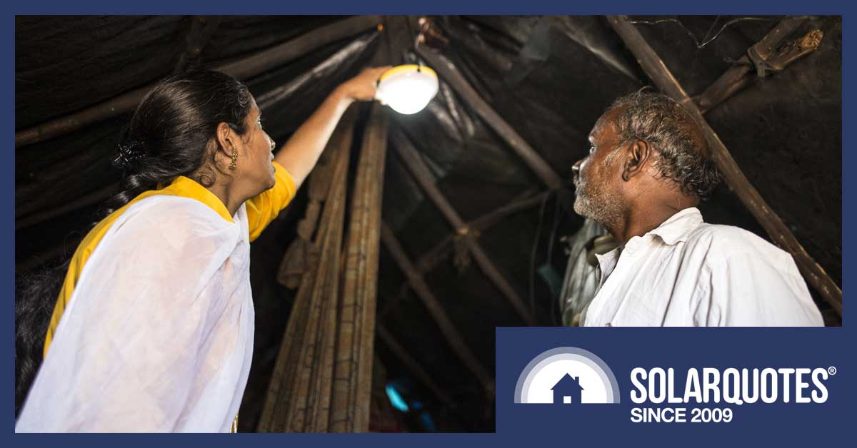 A family in India with a solar powered light