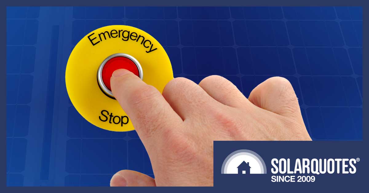 a hand pressing an emergency stop button