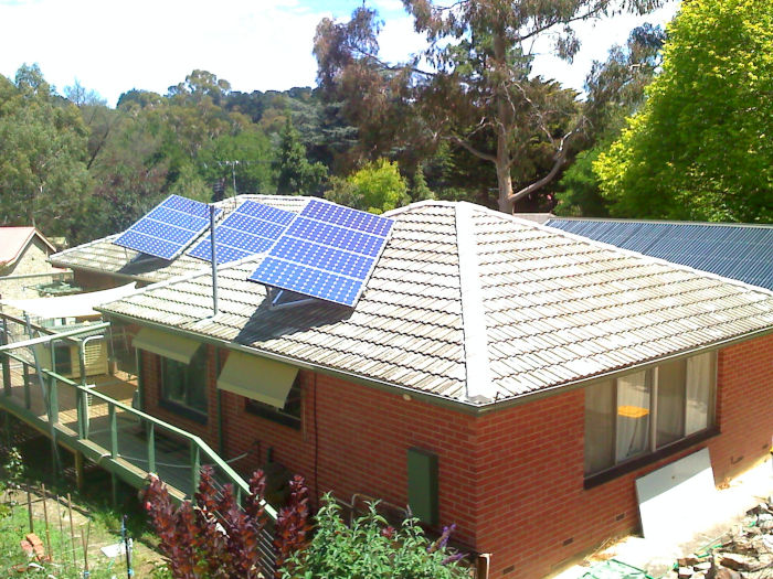 Angled solar panel array frame on tile roof