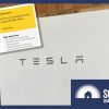 a tesla powerwall on a brick wall