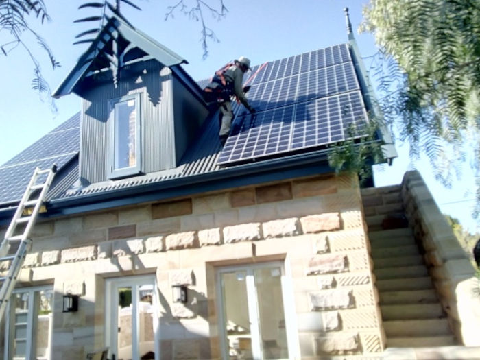 Steep roof with dormers and solar panel array