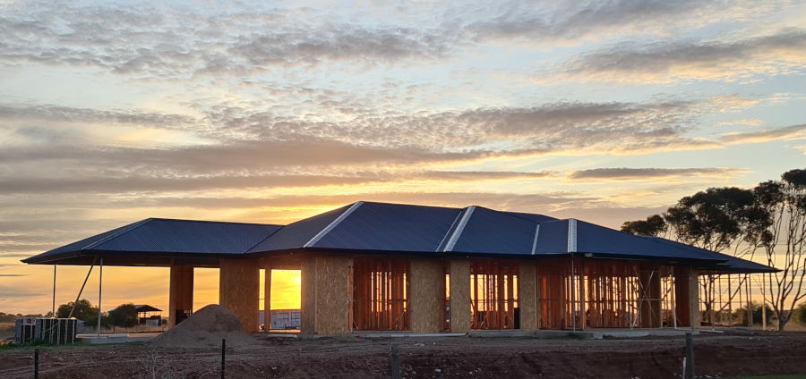 unfinished house with complex roof