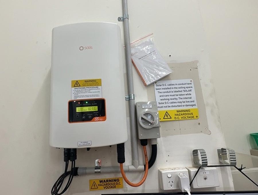 a solar inverter with an incorrectly placed label next to it