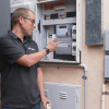 Finn pointing to electricity meter