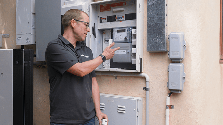 Finn pointing to electricity meter