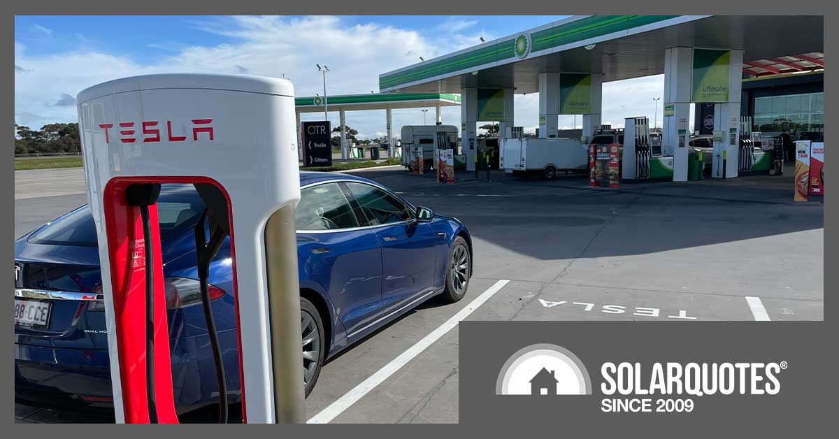 tesla supercharger next to a servo