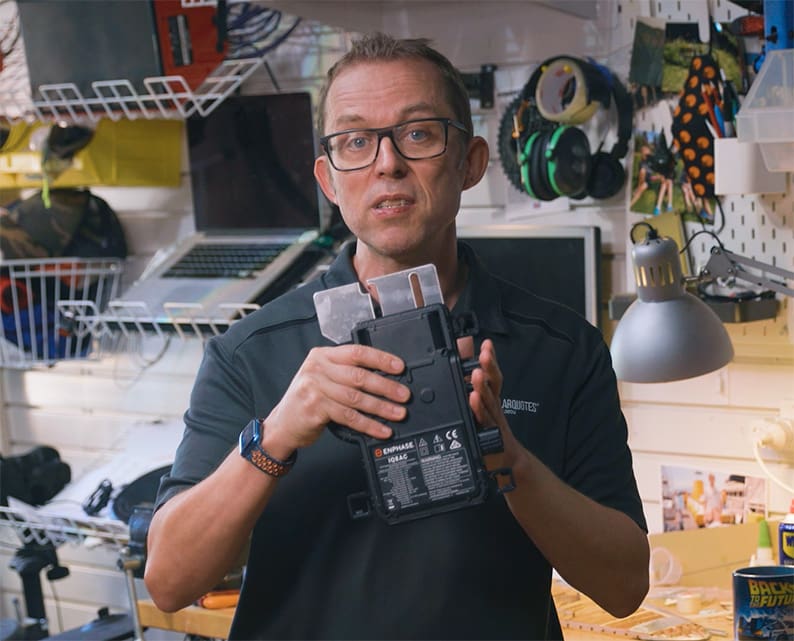 Finn holding an Enphase microinverter