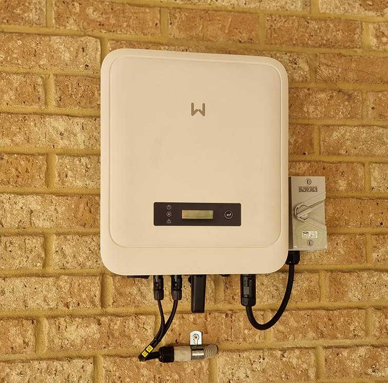 A Goodwe solar inverter on a wall