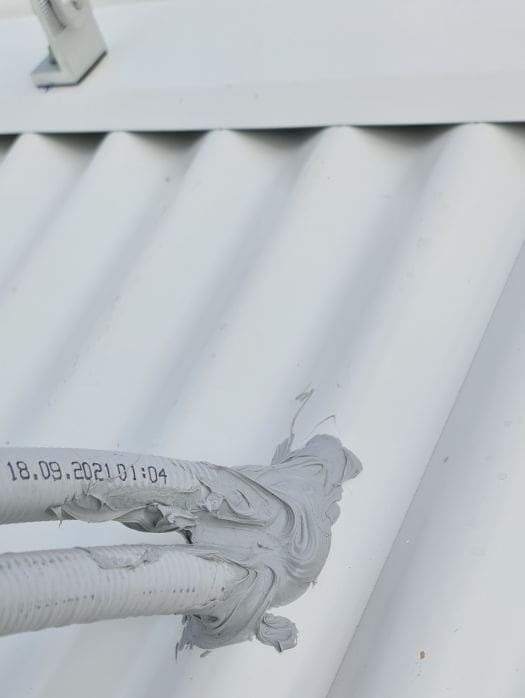 two electrical conduits exiting roof