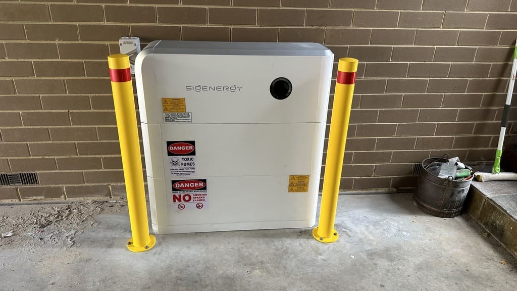 A Sigenergy battery protected by two bollards