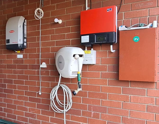 Solar inverters on a house wall.