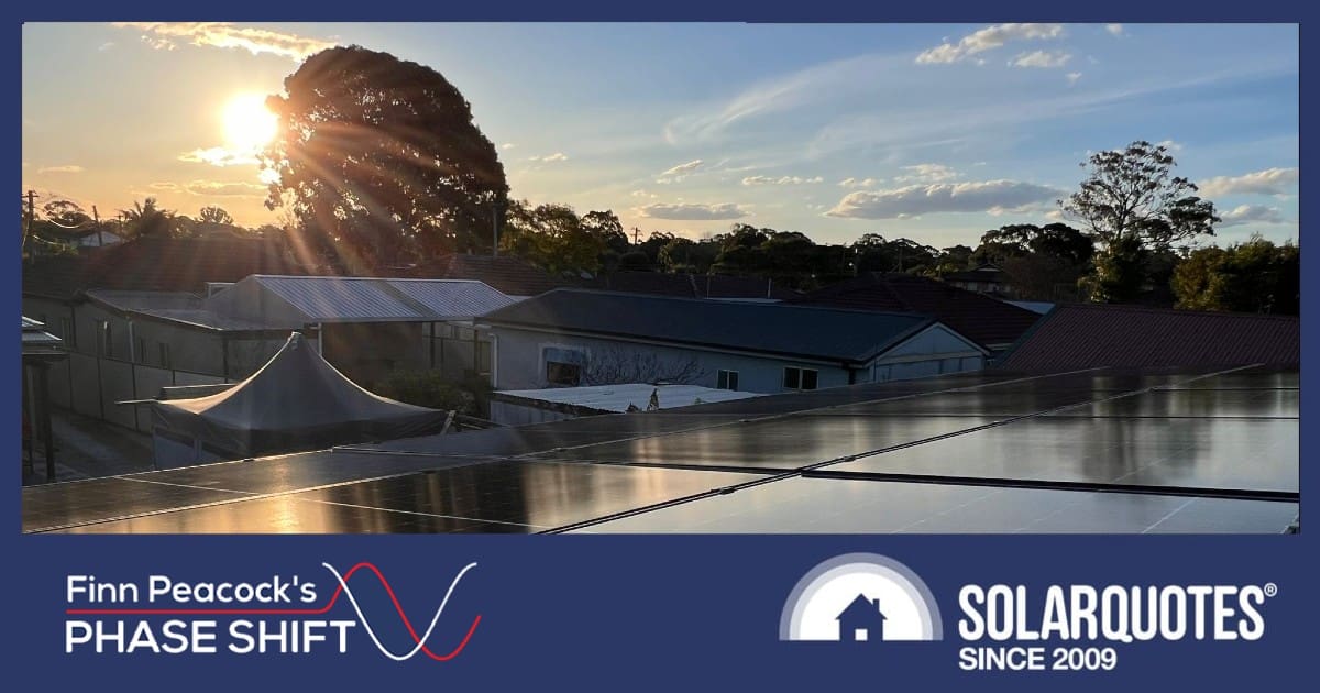 A sun sets over a premium brand of solar panels