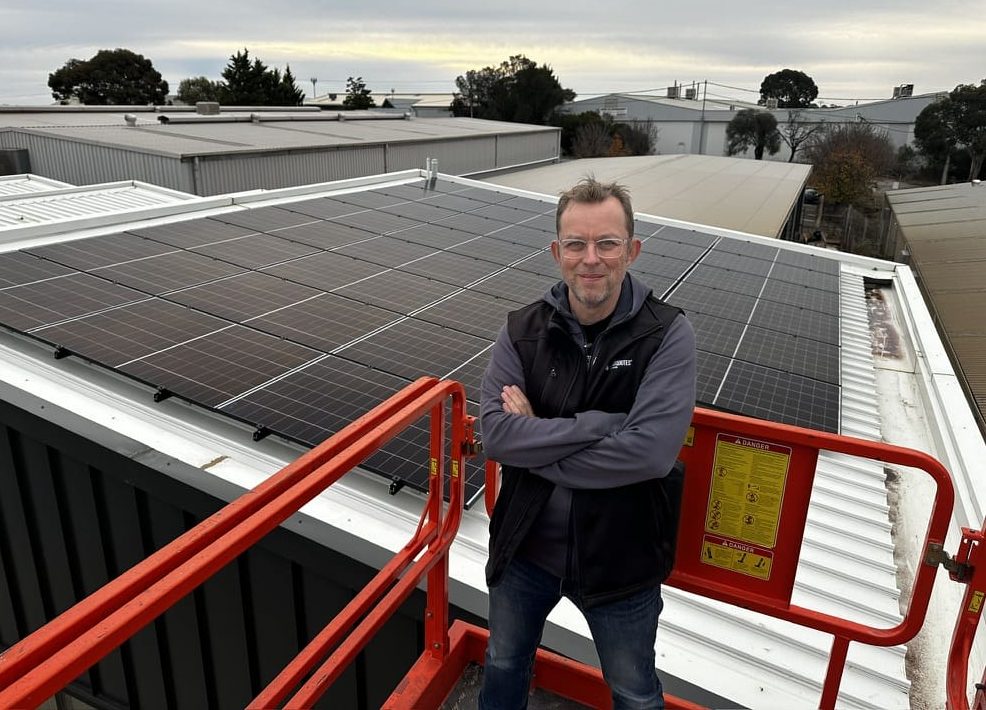 A man standing in front of a solar array.
