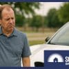 A puzzled man standing next to an EV