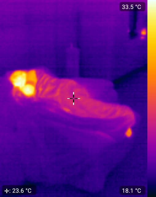 Thermal image of a person on a couch