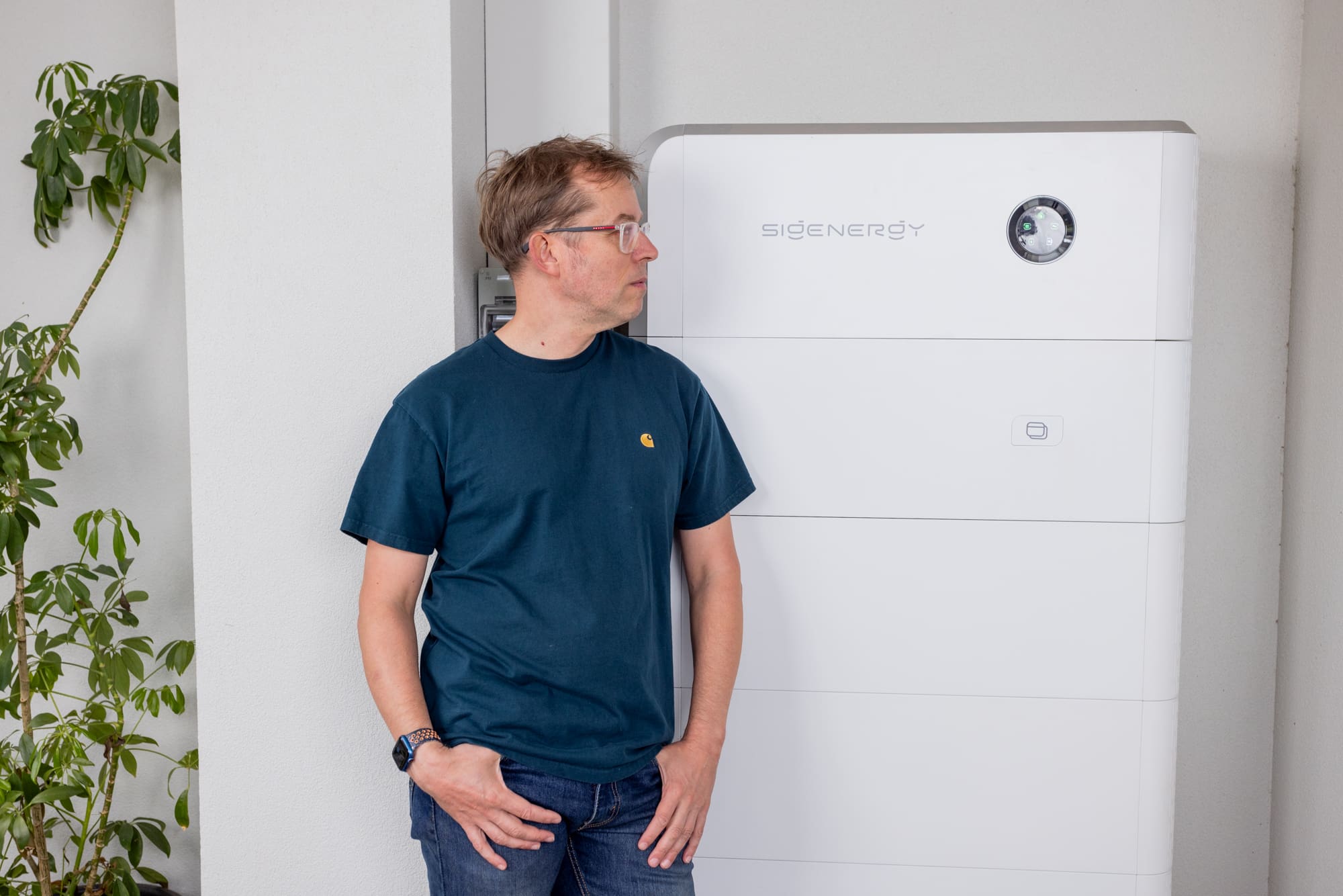 A man looking at a Sigenergy system