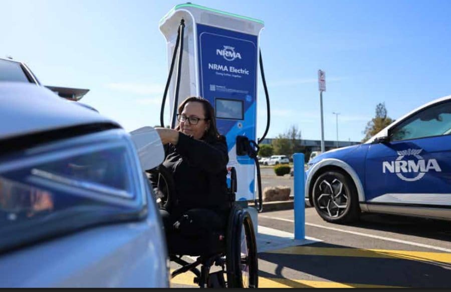 Disabled person at an accessible EV charging station.