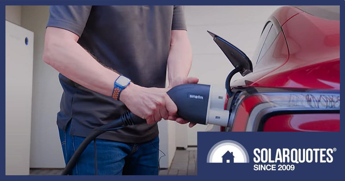 A bidirectional V2G charger being plugged into an EV port