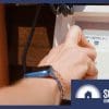 A hand turning a hot water heat pump timer