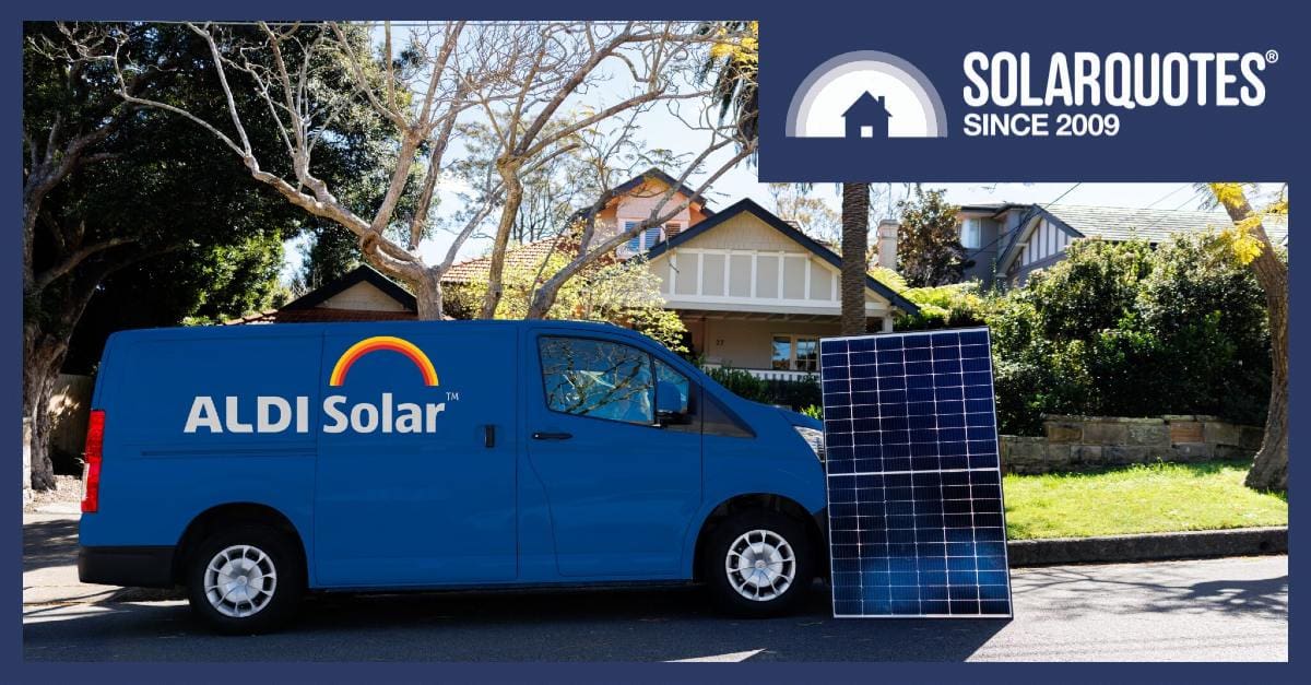 An Aldi Solar van next to a solar panel