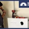 Someone installing a battery