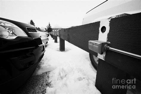 car parked next to power outlet in the snow