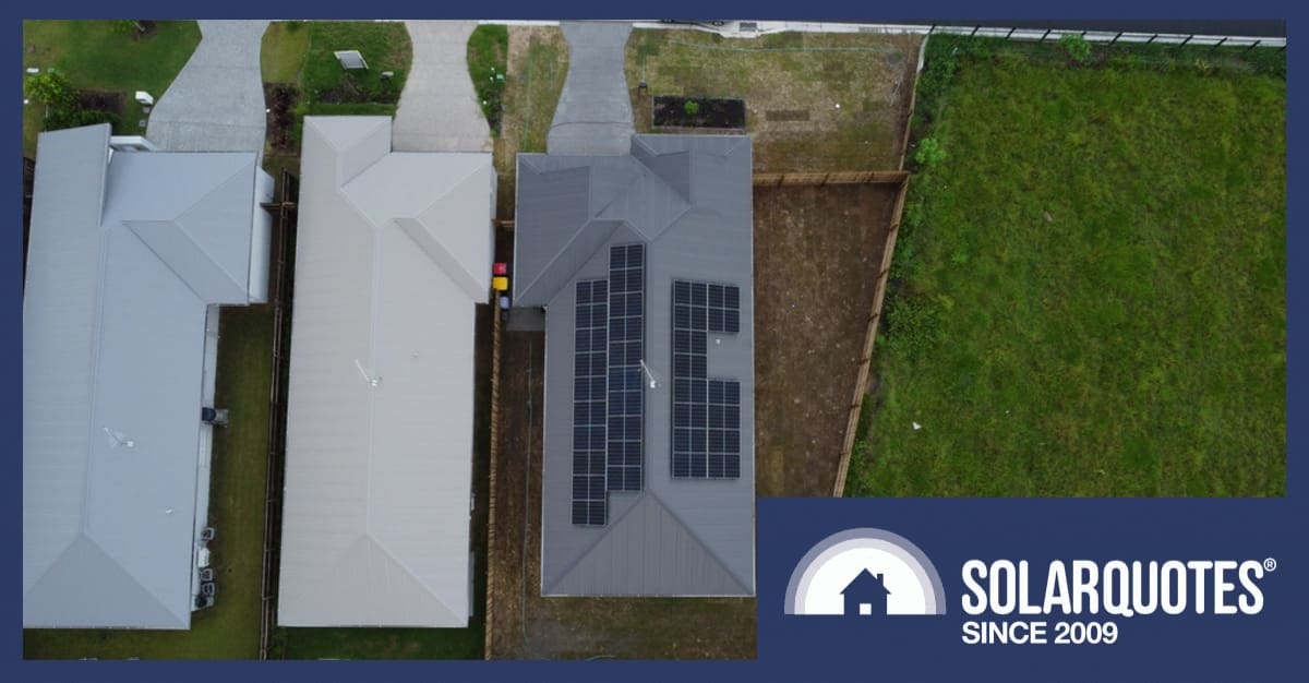 A rooftop with solar next to rooftops without solar