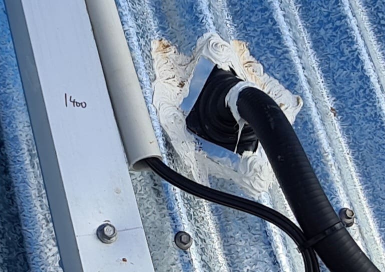 Solar DC cable exiting from a roof