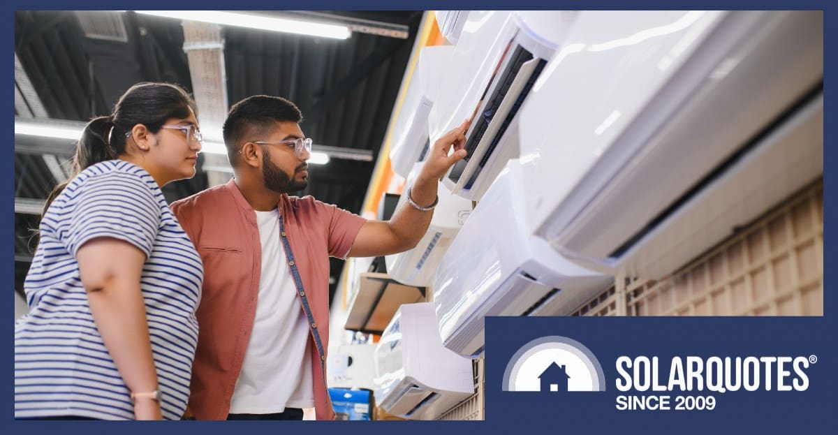 people inspecting an air conditioner