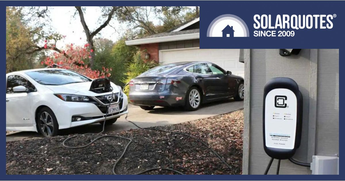 Two EVs charging in a driveway with an EV charger on the garage.