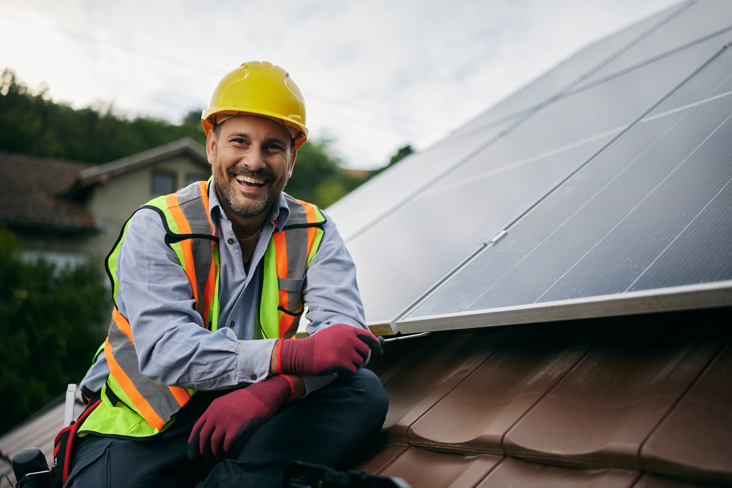 A solar installer stock image with a hard hat