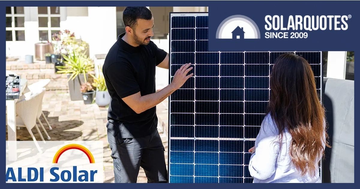 Man showing woman solar panel.