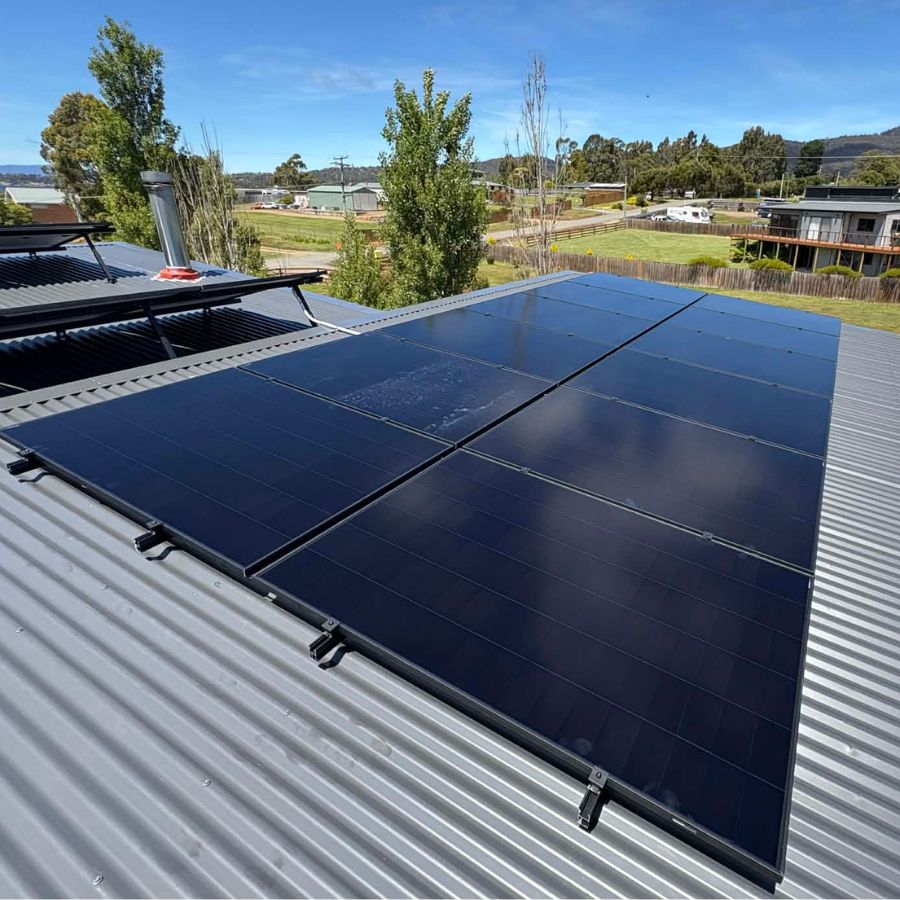 AIKO solar panels on a tin roof.