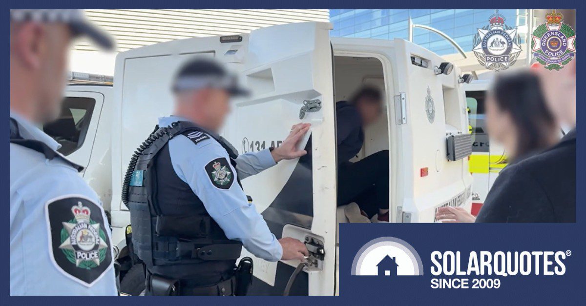 A man getting hauled into a paddy wagon.