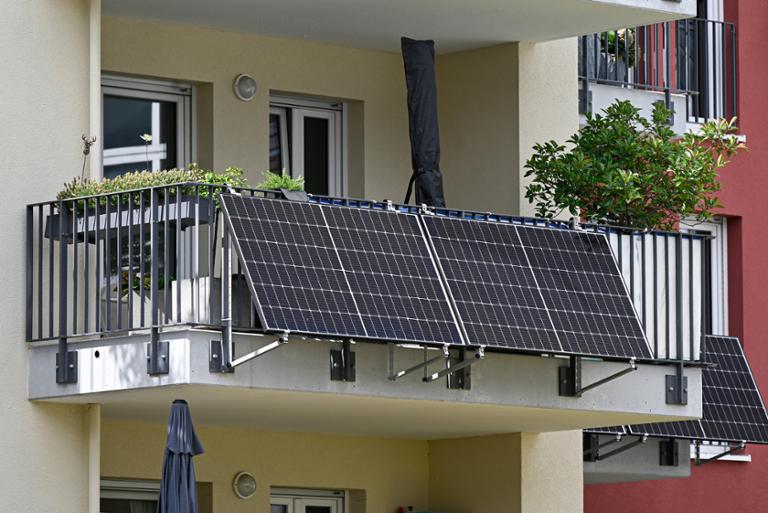 Solar panels on the side of a balcony.