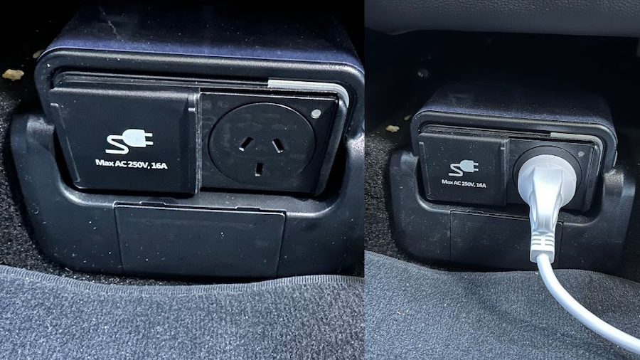 A black V2L charging socket with cable plugged in.