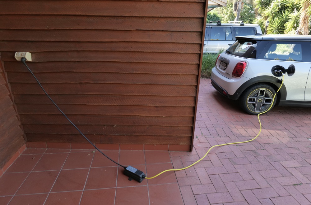 A mobile charger connects a standard power point to an EV.