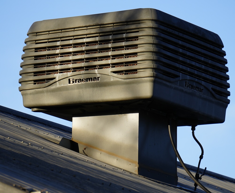 Braemar roof-mounted evaporative air conditioning unit with dropper duct, showing the outdoor component of a whole-home evaporative cooling system.