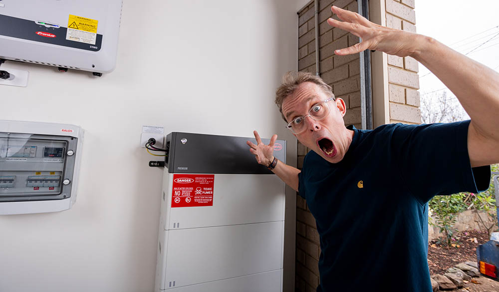 Finn Peacock next to a BYD battery