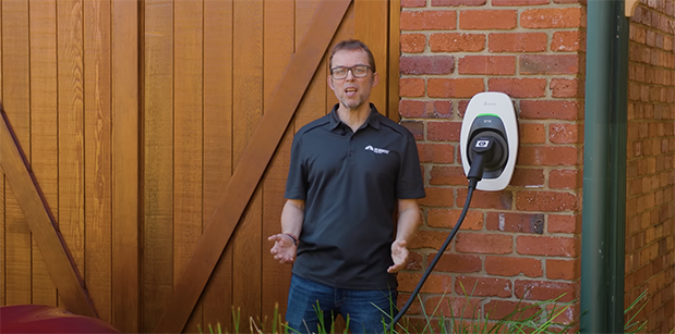 finn peacock standing next to his Delta ev charger